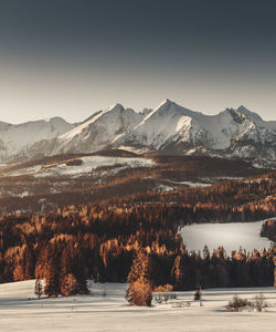 Scenic view of snowcapped mountains against sky during sunset