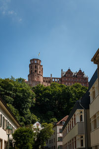 Low angle view of buildings against clear blue sky