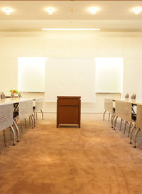 Empty chairs in illuminated room