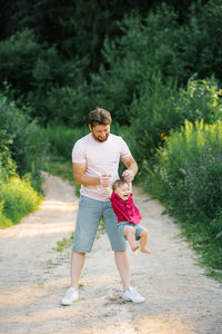 Father and son play together in the park and have fun person