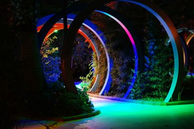 Illuminated tunnel at night