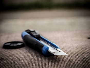 Close-up of utility knife on table