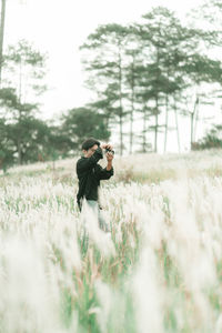 Side view of man standing on field