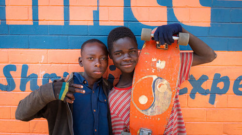 High angle view of young kids standing against wall