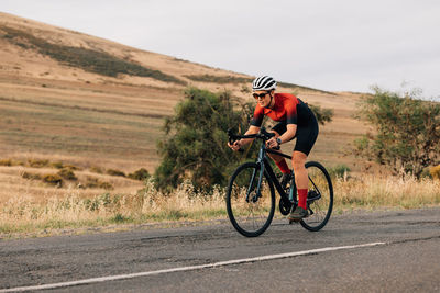 Man riding bicycle on field