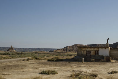 Built structure on desert against clear sky