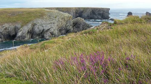 Scenic view of sea with mountain range in background