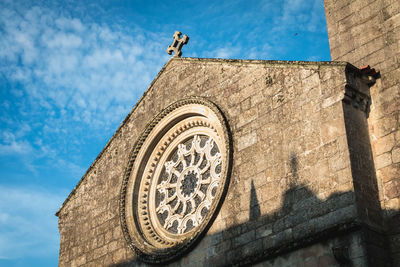 Low angle view of clock tower against sky