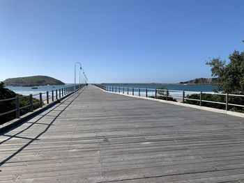 View of pier over sea against clear sky