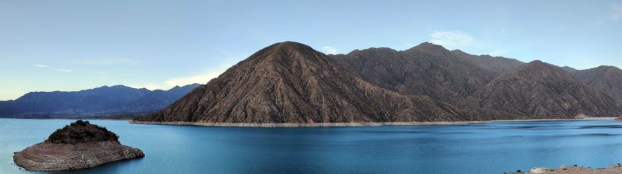 Panoramic view of rocks in lake against sky