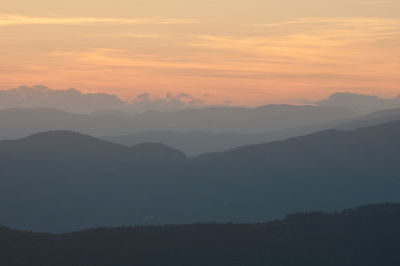 Scenic view of silhouette mountains against sky during sunset