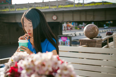 Woman having drink at sidewalk cafe