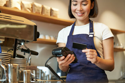 Portrait of young woman using mobile phone