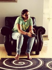 Portrait of young man sitting at home