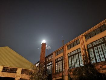 Low angle view of buildings against sky at night