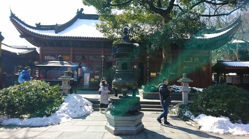 Statue against trees and building