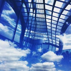 Low angle view of modern building against blue sky