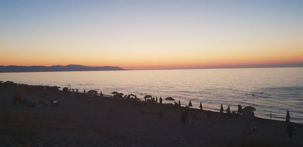 Scenic view of sea against clear sky during sunset