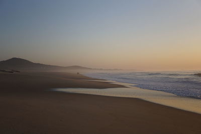 Scenic view of sea against clear sky during sunset