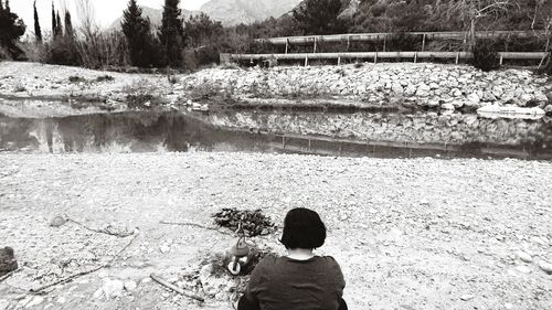 Rear view of boy looking at lake