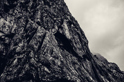 Low angle view of rock formation against sky