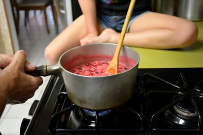 Midsection of man preparing food in kitchen