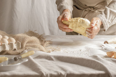 Midsection of woman holding seashell at home