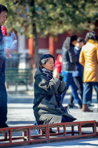 People looking away while sitting in winter