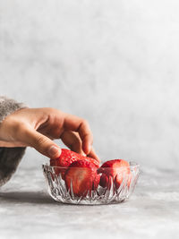 Close-up of hand holding strawberry