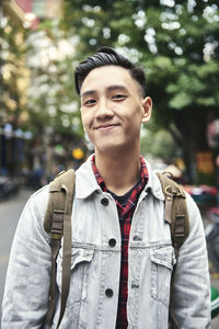 Portrait of smiling young man standing outdoors