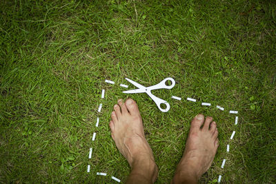 Low section of person legs on grass field