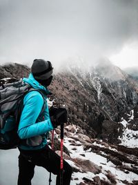 Rear view of man skiing on snowcapped mountain