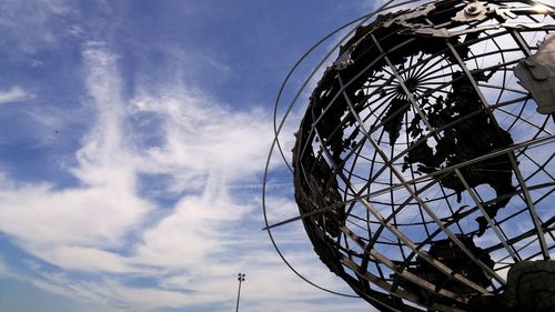 Low angle view of metal globe against sky