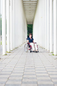 Woman sitting on footpath