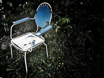 High angle view of abandoned chair on field