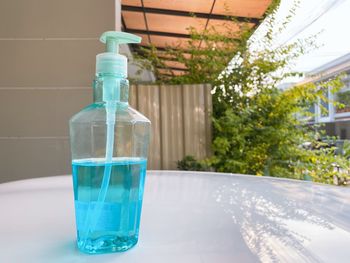 Close-up of glass of water bottle on table