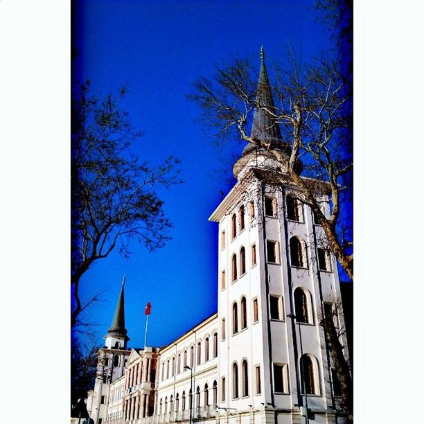 building exterior, architecture, built structure, blue, low angle view, church, religion, clear sky, place of worship, city, spirituality, tower, tree, dome, auto post production filter, cathedral, spire, sky