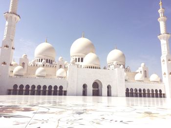 White mosque against sky during sunny day