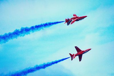 Low angle view of airshow against sky