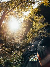 Portrait of man on tree in forest