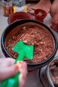 Gardening at home. transferring soil from one pot to another.