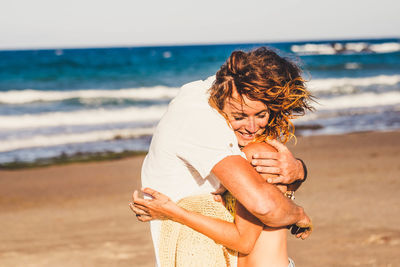 Couple embracing at beach