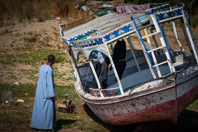 Side view of man standing on boat