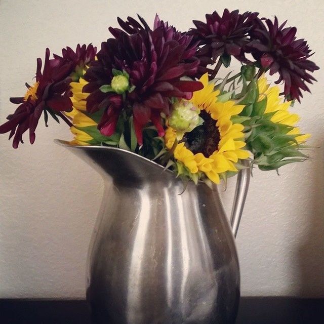 indoors, flower, vase, still life, table, decoration, freshness, wall - building feature, home interior, art and craft, flower arrangement, fragility, close-up, creativity, petal, yellow, art, studio shot, bouquet, floral pattern