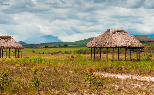 Built structure on field against sky