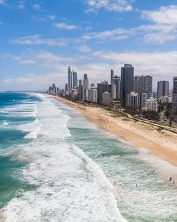 Panoramic view of beach and buildings against sky