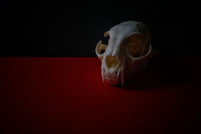 Close-up of figurine on table against black background