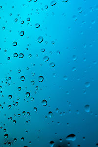 Full frame shot of raindrops on blue sky