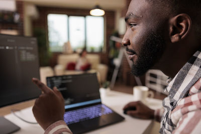 Close-up of man using laptop