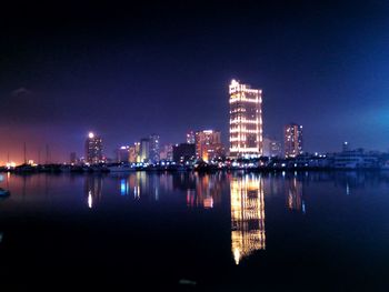 Reflection of illuminated buildings in water at night